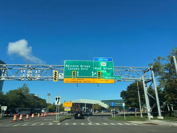 signs for the rainbow bridge from new york state to canada