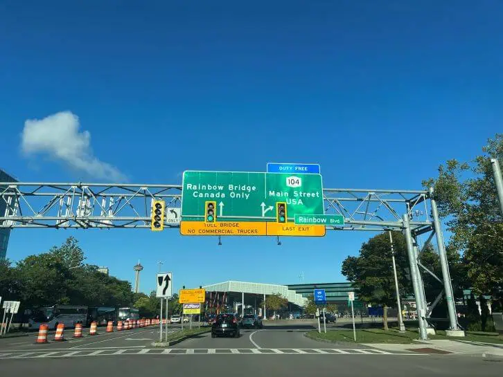 signs for the rainbow bridge from new york state to canada
